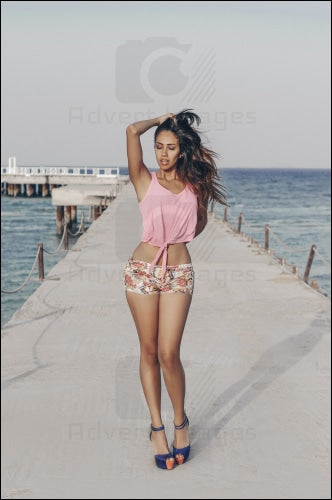 Egyptian Arab Model Standing On A Bridge The Red Sea Posing In Wind With Pink Shirt & Jeans Shorts