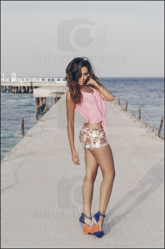 Egyptian Arab Model Standing On A Bridge The Red Sea Posing In Wind With Pink Shirt & Jeans Shorts