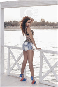 Egyptian Brunette Model Posing Standing On A Bridge Above Red Sea Water With Black Shirt & Blue